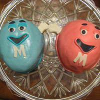 M&m Mini Cakes My second cakes...all fondant, except for the eyebrows and eyes. (gum paste)Two carved out 6 inch chocolate cakes, with chocolate butter...