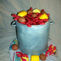 Crawfish Boil Cake Iced in buttercream with fondant crawfish, corn, & potatoes.