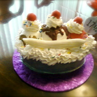 Banana Split Oval WASC cake base, mini ball pans for the scoops of ice cream, fondant bananas and cherries, buttercream whip cream and melted chocolate...