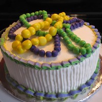 Mardi Gras Cake Fudge Marble Cake with buttercream icing. The bead necklaces are fondant strung on thread.