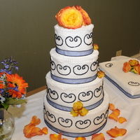Navy Blue Scroll This cake had navy blue ribbon and piping with decorative pearl strand on edges. Navy blue is a hard color to get. The flowers added the...