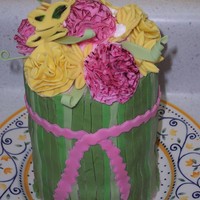 Fondant Flowers OK this didn't turn out like I wanted. It's 3 layers of 2 inch rounds with fondant flowers. I still want to pull this off so...