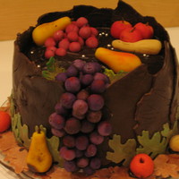 Fall Groom's Cake Three layers of Tangerine cake filled and frosted with Chocolate Syrup butter cream. The large leaves are chocolate clay; the fruit is...