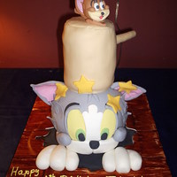 Tom & Jerry Cake I did this cake for a 6 yr. olds surprise birthday party. The cake was red velvet. Tom's head and the mallet are cake. Little Jerry...