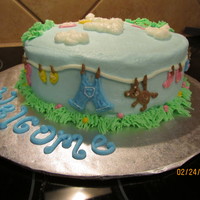 Love On The Line... all butterecream piping. Baby clothesline wraps around this cake and on top.