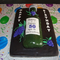 50Th Birthday Cake. This was a cake for a husband and wife who were both turning 50. The sheet cake is covered with dark chocolate fondant. The wine bottle is...