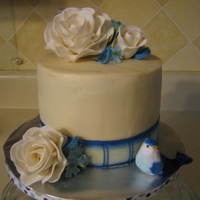 Rose Birthday Cake Chocolate cake with buttercream icing and gumpaste flowers. The bird is not gumpaste. It is from hobby store.