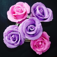 Rose Cake Pops Cake pops covered in modeling chocolate roses. TFL!