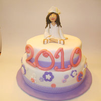 Shana'a Graduation Cake 2 tier cake covered in fondant with fondant figure on top.