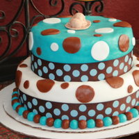 Erin's Baby Shower Cake Chocolate caramel and french vanilla. Covered in buttercream with Blue and white fondant and brown and white accents.