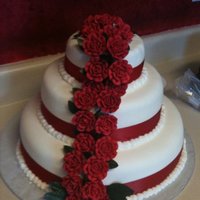 Rose Wedding Cake This is a 6 in, 10 in, and 14 in tier wedding cake. The roses are sugar roses and attached to toothpicks with royal icing. The leaves are...