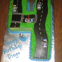 Number 4 Race Car Cake Marshmallow Chocolate Fondant Road, Everything else is buttercream. Cars are chocolate wrapped in foil.