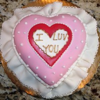 Mini Valentine Heart Pillow Cake 5" heart cake, edges rounded for pillow shape, covered in fondant, fondant ruffle, royal icing edging.