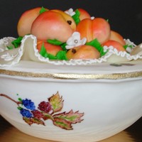 Peaches In An Evesham Bowl Bowl is an all butter pound cake covered in fondant and hand painted. I made the peaches out of fondant as well.