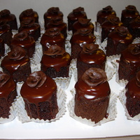 Chocolate Ganache Petit Fours 2" round chocolate cakes with chocolate buttercream icing and chocolate ganache poured on top. Mini hand molded rose from dark...