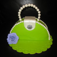 Purse Cake It's made out of a round pound cake and I cut them in half and stick them together. Fondant finish and this is for a 13 yr. old girl&#...
