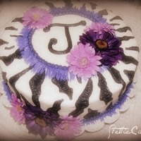 Purple Zebra This cake was done for a friend of mine for her birthday. Iced in buttercream and decorated with silk flowers.