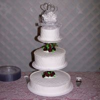 100_5560.jpg My 1st wedding cake.Buttervream icing with burgandy roses. I used the impression mat also.