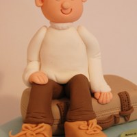 A Man Sitting On Suitcase. 