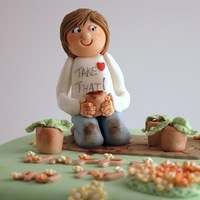 Gardening Birthday Cake A lady, very keen on gardening, planting in little pots. She is all muddy from her work.