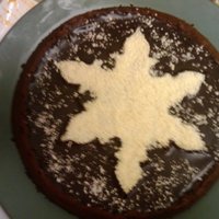 Truffle Torte Dark Chocolate Brownie Torte with Ganache and White Chocolate shavings on top.