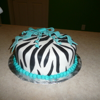 Zebra Cake Zebra print fondant with teal bow and curly-q's.