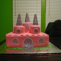 Princess Castle 3 high rectangle cakes with 2 and 3 level high mini round cakes. All covered in pink MMF. Peaks of towers are ice cream cones covered in...