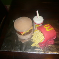 Mcdonalld's Meal Cheeseburger and fries made out of cake, covored in MMF. Fries are thick slices of MMF. Drink is RKT covored in MMF. Buttercream details....