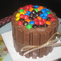 Mini Candy Cake Chocolate cake with chocolate buttercream filling, with Kit Kats and M&M's.