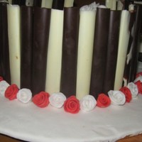 Valentines Day Cake Chocolate cake, with chocolate butter cream. Chocolate sticks and fondant mini roses.