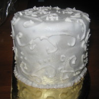 Piping Practise Mini Cake Chocolate mini cake with chocolate buttercream filling, white fondant, pearl lustre and royal icing piping. Made specifically to practise...