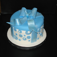 Gift Box Cake round gift box cake, covered in fondant with gumpaste bow.