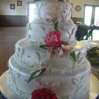 Spring Wedding This is my first Fondant Wedding Cake. The filling is Confetti with Butter-Cream. The flowers are real as per the brides request. The...
