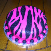 Hot Pink Zebra Birthday Red velvet cake with cream cheese buttercream. Covered in homemade MMF and black sanding sugar on the stripes.