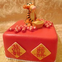 Year Of The Tiger! A chinese new year cake made with red fondant and gold chinese double happiness symbols. 2010 is the year of the Tiger and so the cake is...