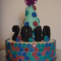 New Years Cake Buttercream icing with fondant details. The hat is made out of cake and icing. This is my first cake and first time working with fondant.