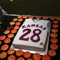 Ku Basketball Groom's Cake And Cupcakes Chocolate cake with raspberry filling. Basketballs and jersey are covered in fondant