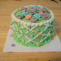 Mother's Day 6" white chocolate cake with cheesecake mousse and white chocolate frosting. Purple, pink and blue roses (though the pic makes them...