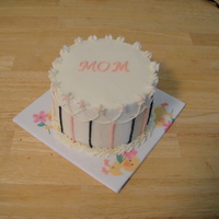 Mother's Day 6 " white chocolate cake with cheesecake mousse and white chocolate frosting.