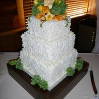 Simple Coconut Covered Cake A simple 3 tier square covered in coconut flakes and topped with fresh flowers. Simple and elegant.