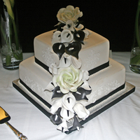 Black And White Calla' And Rose' A simple 2 teir square with white on white stenciling and gum paste, roses, rose buds, leaves and calla's.