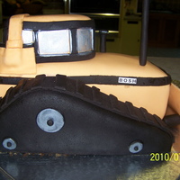Bulldozer Yellow bulldozer stacked and carved. Covered in fondant.