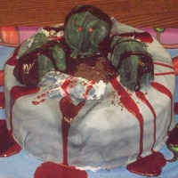 Halloween Cake Halloween cake covered in marble black and white fondant. The zombie is RKT coverd in black and green fondant. The dirt is crushed teddy...