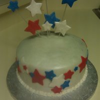 Happy Birthday America! A simple Vanilla cake with buttercream. White fondant airbrushed with pearl and silver. All stars are fondant as well. It was made for a...