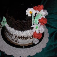 80Th Birthday Cake White and Chocolate Cakes covered in white butterceam and chocolate shavings. All flowers are made with fondant.