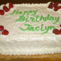 Simple Birthday Cake whip cream covered quarter sheetcake, it is so hard to decorate with cream so we just made some swirls and added a few berries.