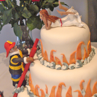 Cake On Fire This was done for our mail lady who was marrying a fireman. The sculptures are gumpaste.