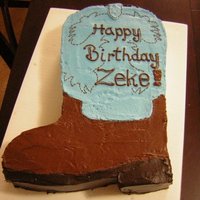 Cowboy Boot Cake two-layered chocolate fudge cake cut out from a 11X15in sheet cake covered and decorated with buttercream. It bothered me that the...