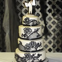 Rachel's Cake 4 tier cake with ribbon edges, fondant and royal icing decorations. This is by far my most favorite cake I've done so far!!!The bride...