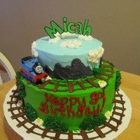 Thomas The Train Cake! This is a 2 tier cake with chocolate chip pound cake, orange butter cake on the top tier. Thomas toy used.